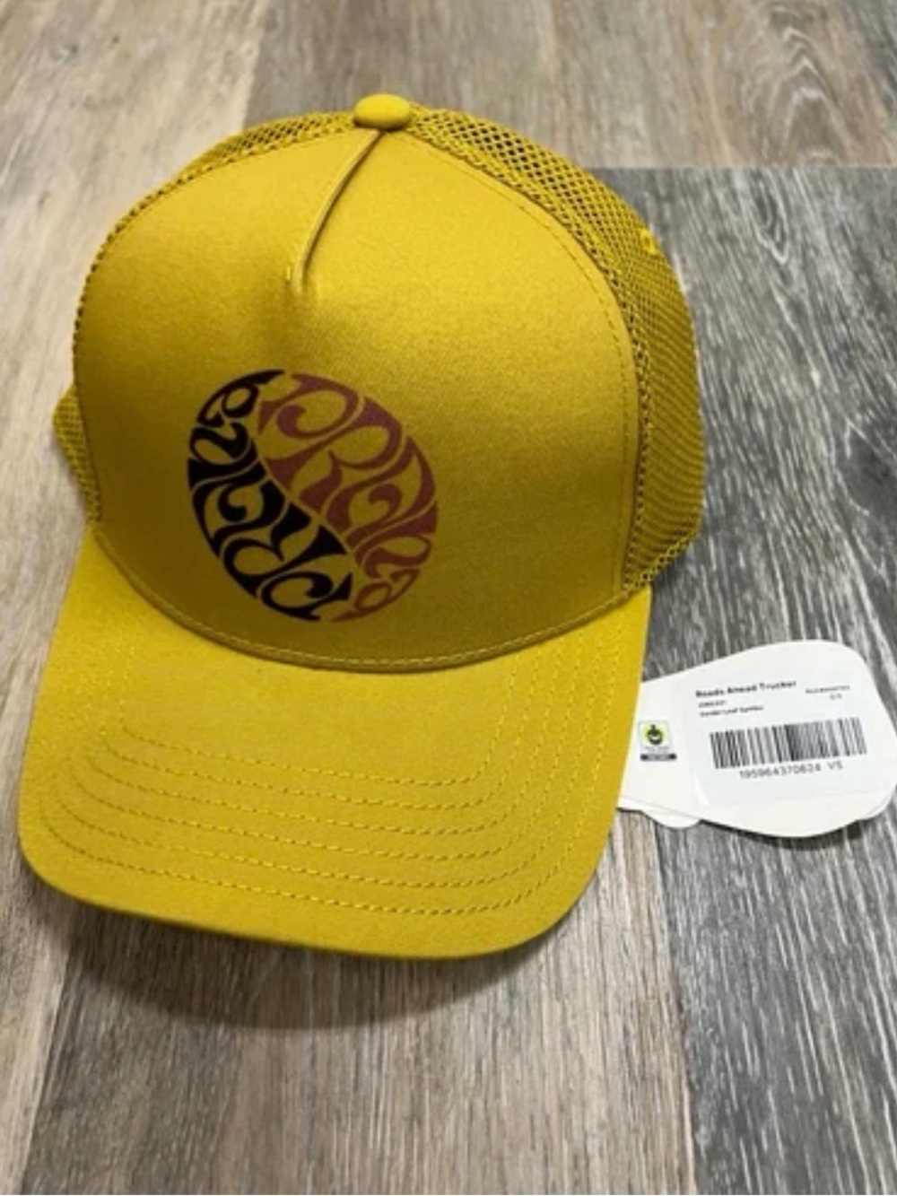 prAna Roads Ahead Trucker Hat in the "Golden Leaf Symbol"